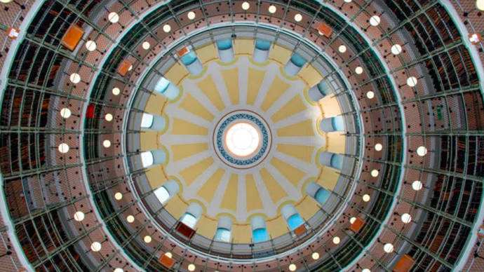 Looking up at a large domed ceiling in a library or archive