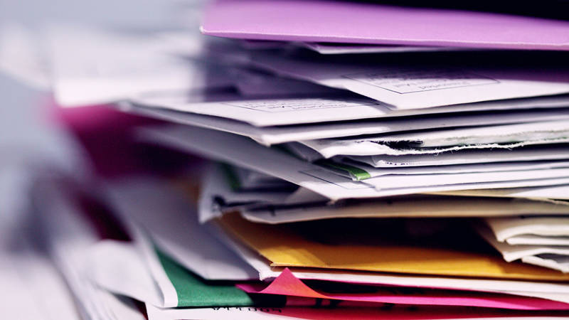 A unordered pile of paper documents