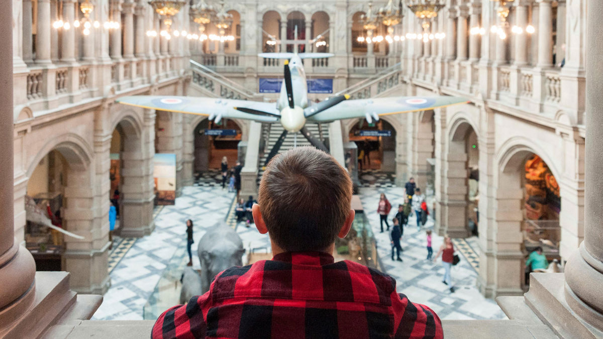 Internal view of Kelvingrove Museum with a boy overlooking the centre hall