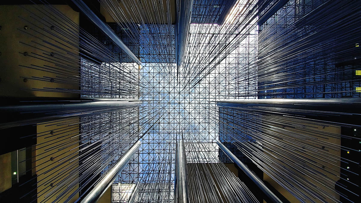 Looking up at the latticed roof of a building