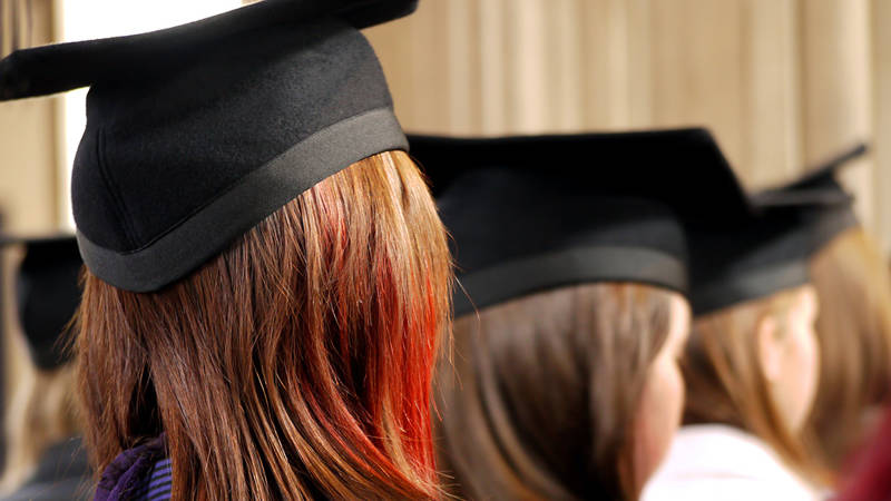 The backs of people's heads at a graduation ceremony